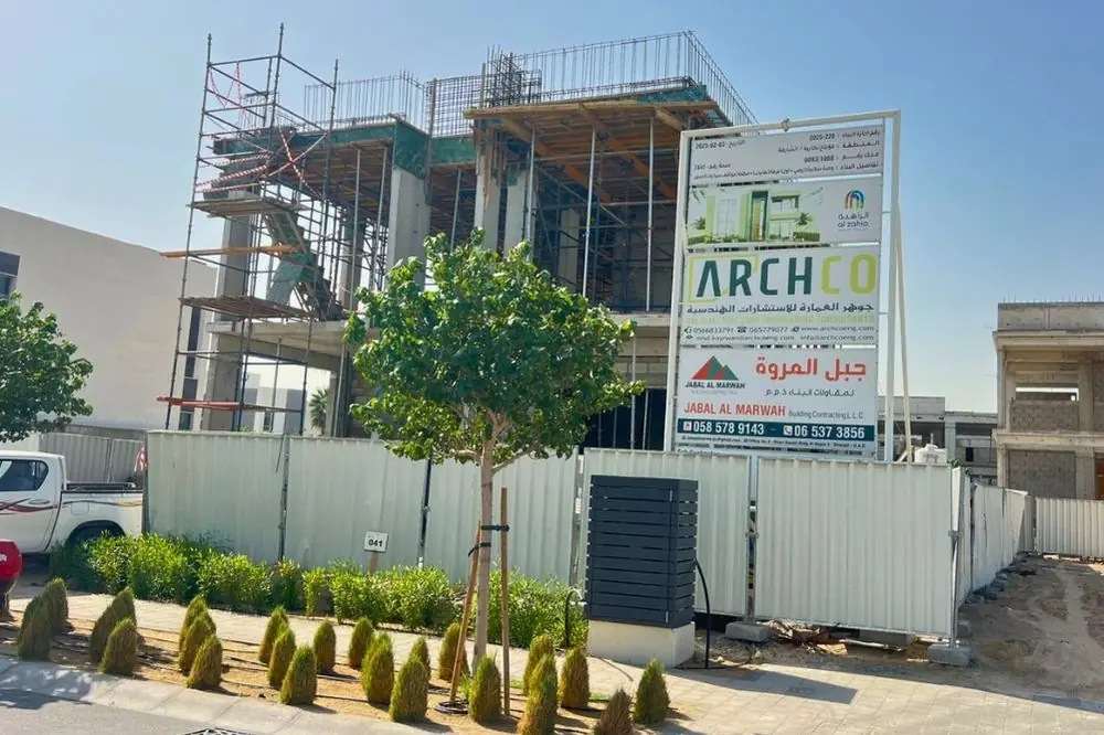 Villa under construction with scaffolding and project signboard, Al Zahia Sharjah