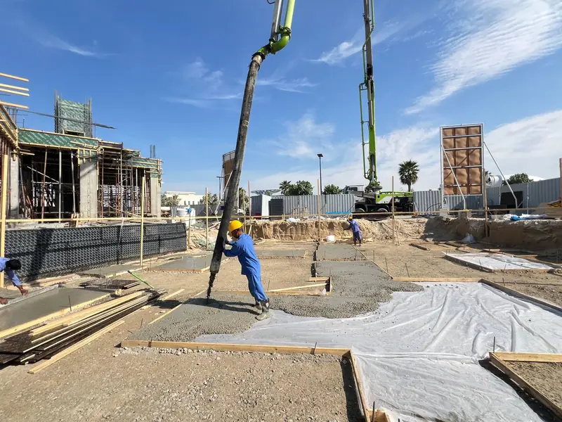 Concrete pump pouring foundation concrete at a Jabal Al Marwah villa site